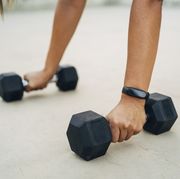 woman during workout with dumbbells