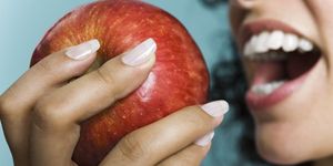 skin, tooth, apple, fruit, mouth, nail, lip, hand, food, plant,