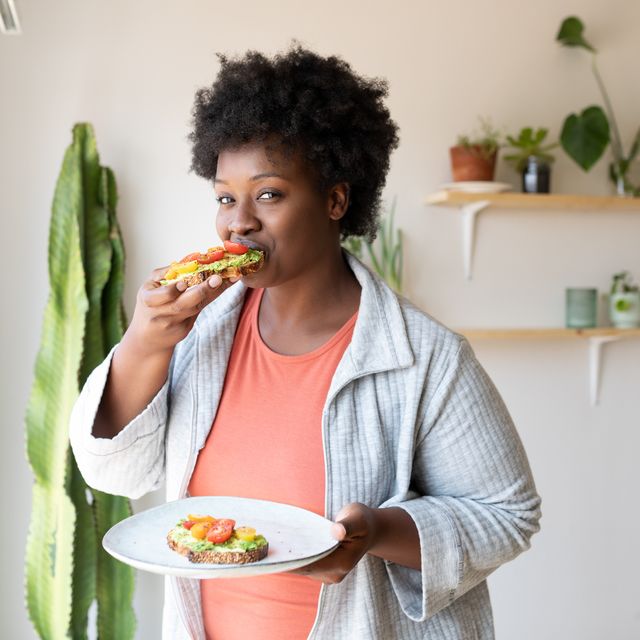 woman eating healthy breakfast at home
