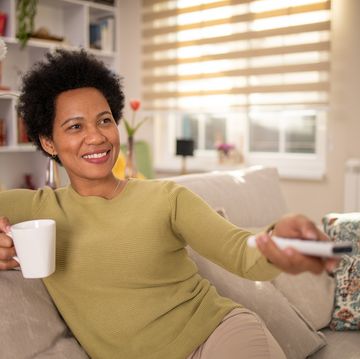 woman enjoying her favorite tv show at home