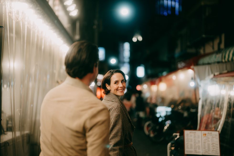 woman enjoying tokyo with her date at night