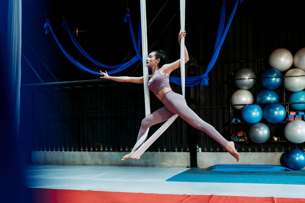 woman exercise the ‎aerial straps‬ clothing in the gym