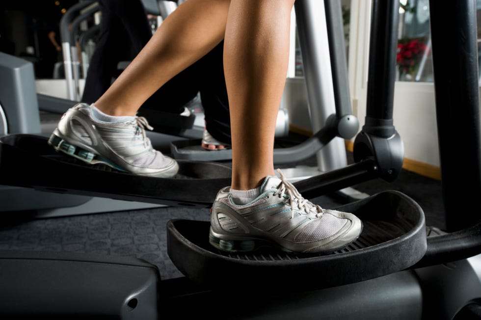 woman exercising on elliptical machine