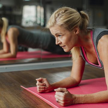 woman exercising on mat