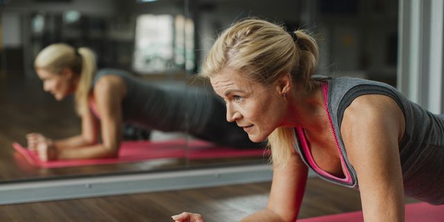 woman exercising on mat