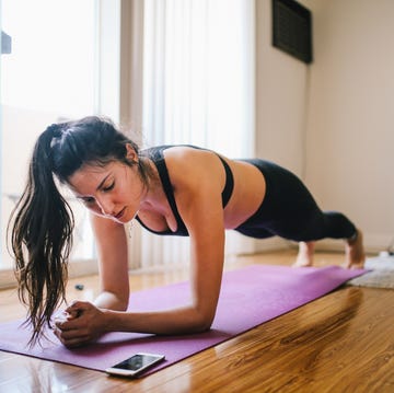 at home cardio workouts woman exercising planks at home in los angeles