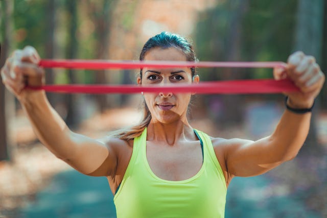 woman exercising with resistance band