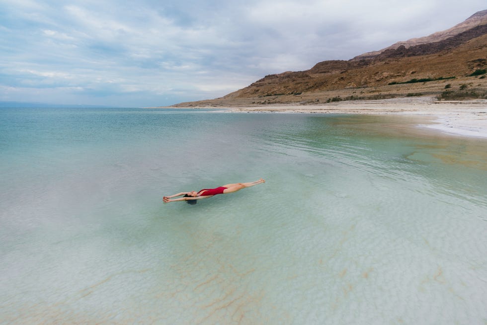 woman floating on water in dead sea