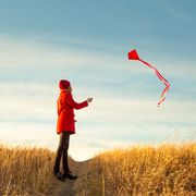 how to fly a kite woman in field