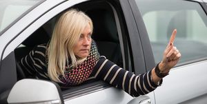 Woman Gesturing While Sitting In Car