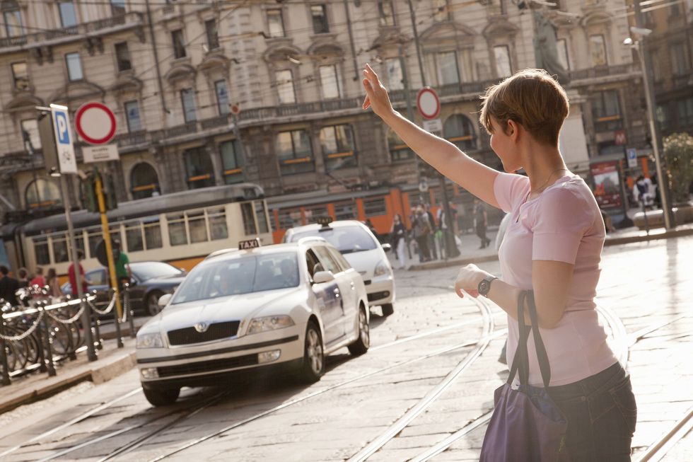 woman getting a taxi in milan