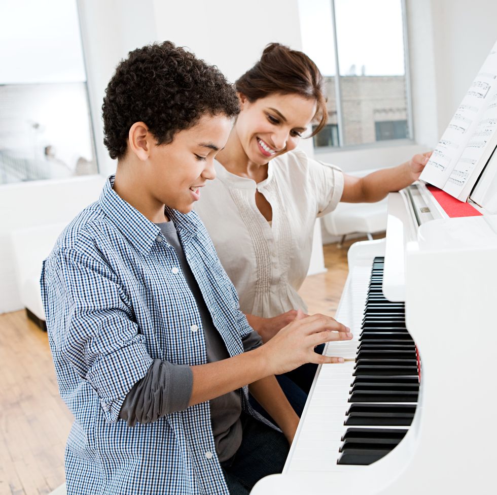 jobs for stay at home moms - Woman giving piano lesson to boy