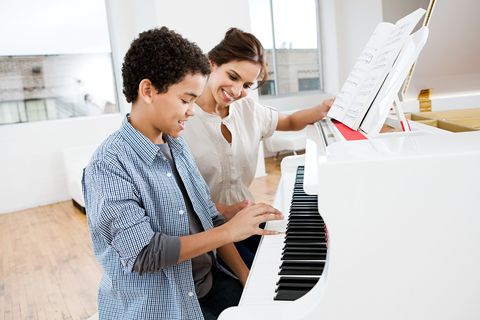 jobs for stay at home moms - Woman giving piano lesson to boy