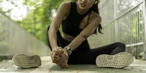 top of foot pain running woman got sport injured while jogging on the street