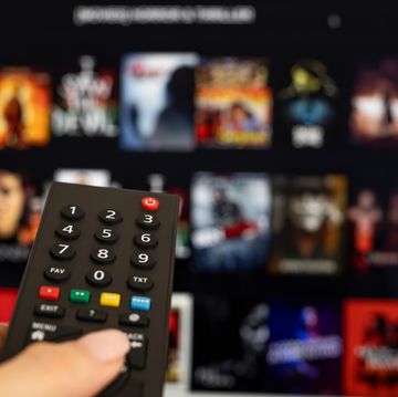 woman hand holding tv remote.