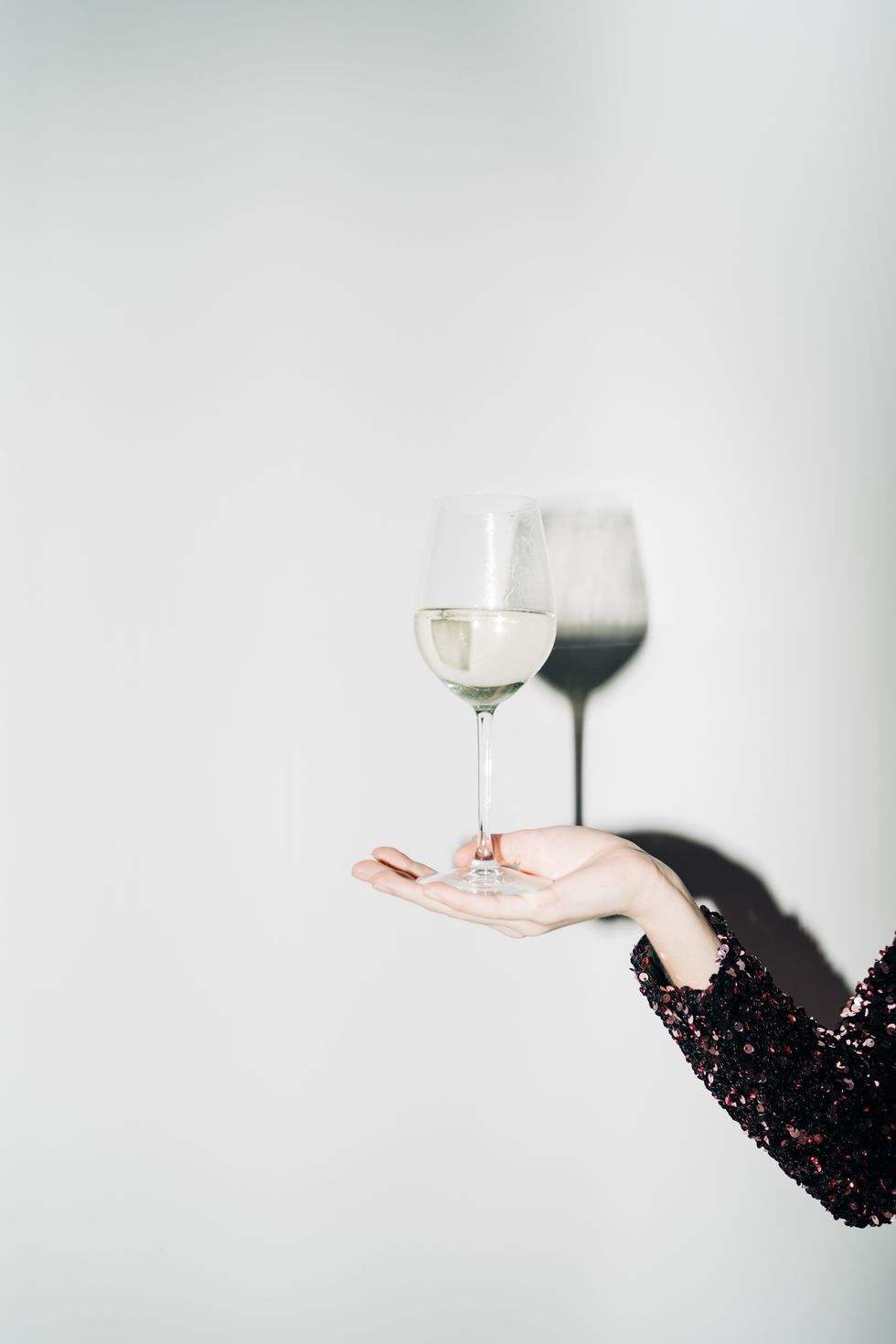 woman hand with champagne glass and harsh light