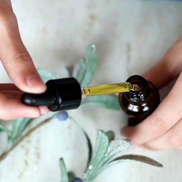 woman hands holding pipette of essential oil