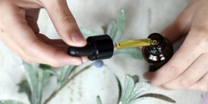 woman hands holding pipette of essential oil