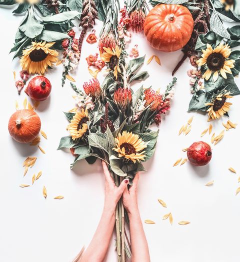 woman hands making autumn flowers bunch