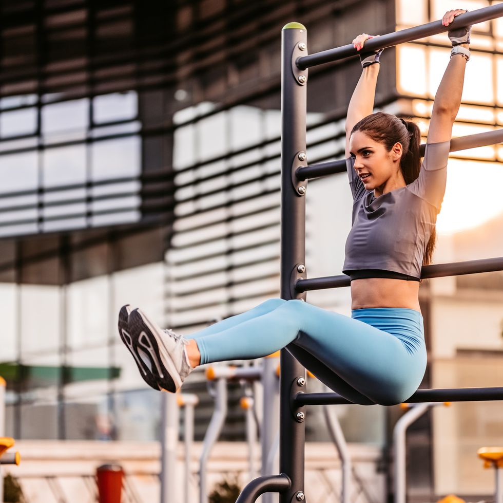 Woman doing hanging leg raises to bar exercise Vector Image