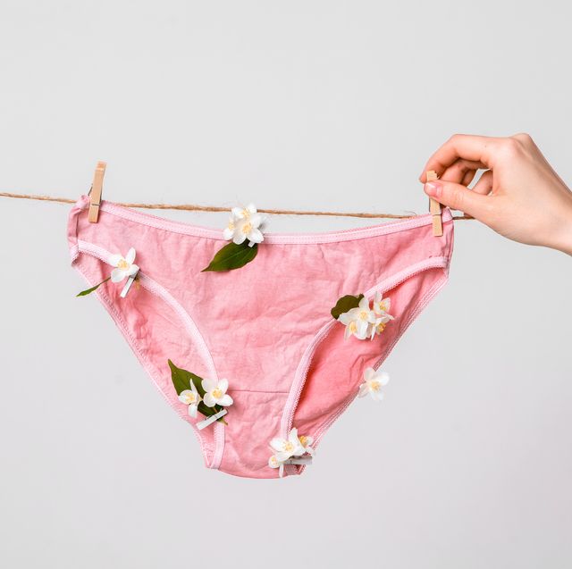 woman hangs underwear with flowers on clothesline, concept content for feminist blog, poster about women's health