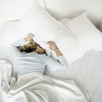 Woman having restless nights sleep