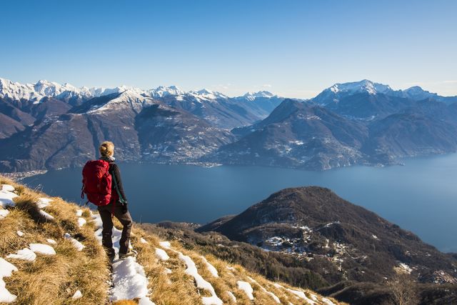 woman hiker on mountain looking at lake