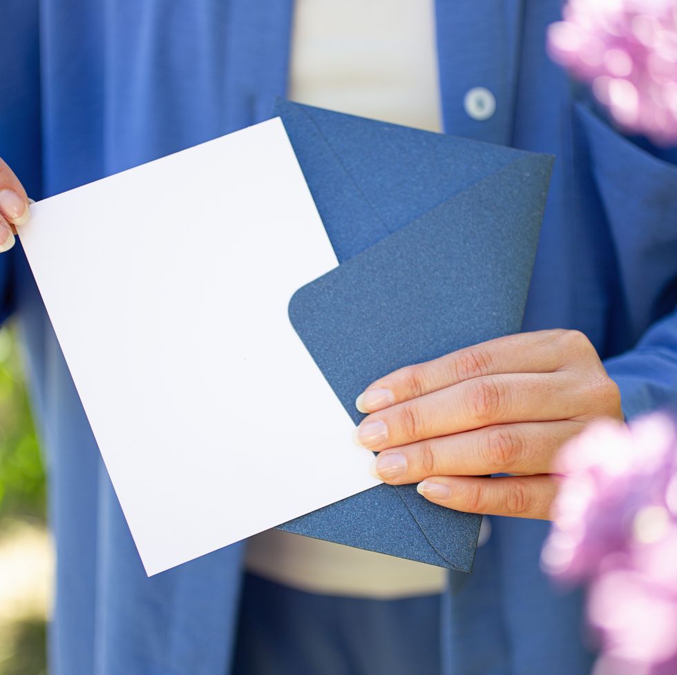 woman holding blank postcard and blue certificate gift,good as mockup.