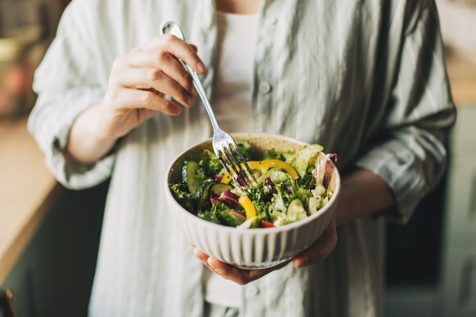 woman holding bowl with products for heart healthy diet, closeup