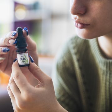 woman holding cbd oil container