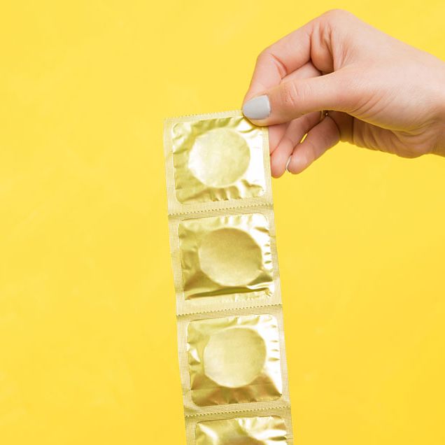 Woman holding pack of condoms