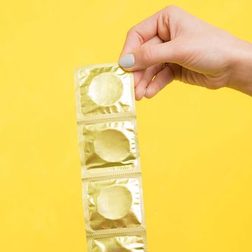 Woman holding pack of condoms