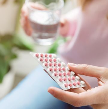 woman holding contraceptive pill