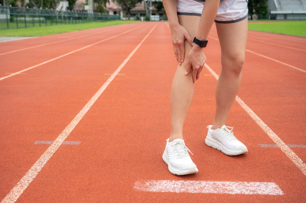 woman holding her knee while she having suffering from knee pain after running