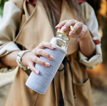woman holding reusable glass bottle