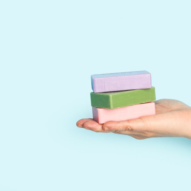 woman holding soap bars with her hand