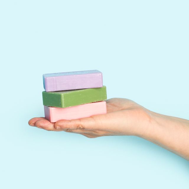 woman holding soap bars with her hand