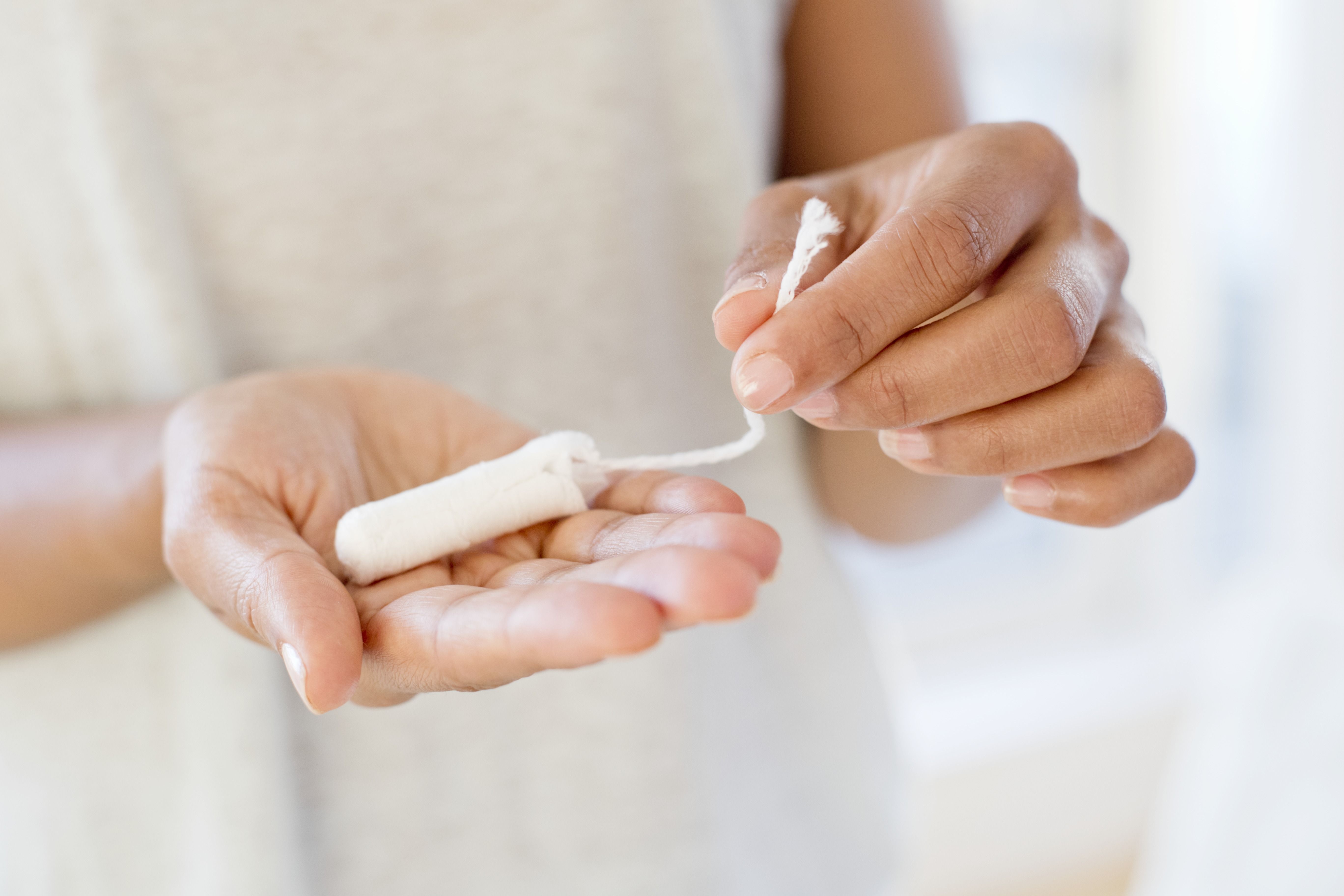 Woman holding tampon