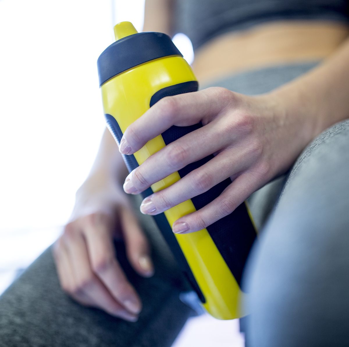 https://hips.hearstapps.com/hmg-prod/images/woman-holding-water-bottle-in-gym-royalty-free-image-670886193-1546447760.jpg?crop=0.669xw:1.00xh;0.166xw,0&resize=1200:*
