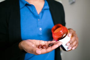 woman holds fruit flavored multivitamins
