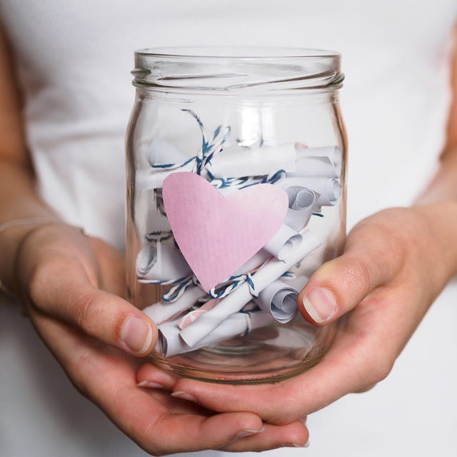 woman holds jar with heart in her hands