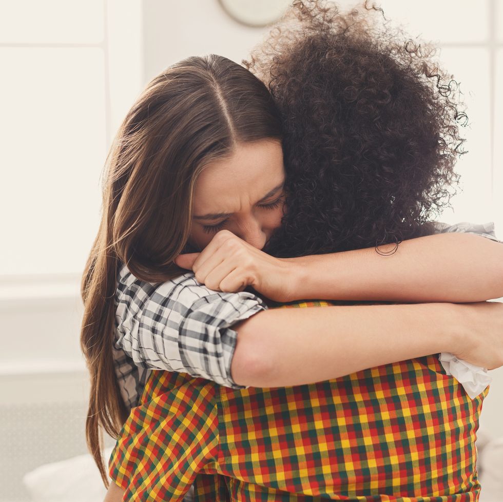 how to forgive yourself woman hugging her depressed friend at home