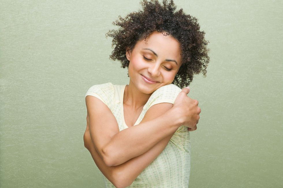 what is an empath  woman hugging herself