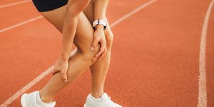 woman hurted ankle on running sports track spasm and pain, female health problems in professional sports