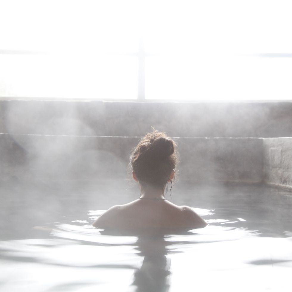 woman in an outdoor bath with steam