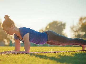 Woman in Chaturanga Dandasana Yoga pose - plank position