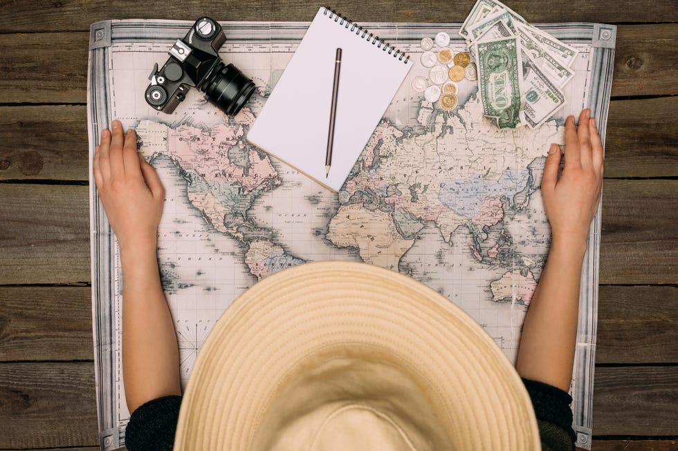 woman in hat with map