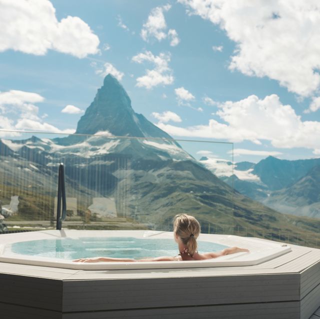 woman in hot tub looking at mountains