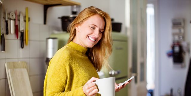 Woman in kitchen with coffee