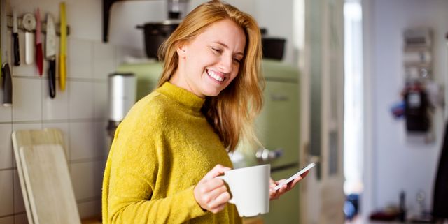 Woman in kitchen with coffee